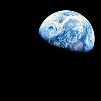 Vibrant Earth from space: swirling clouds, blue oceans, green continents against black void.