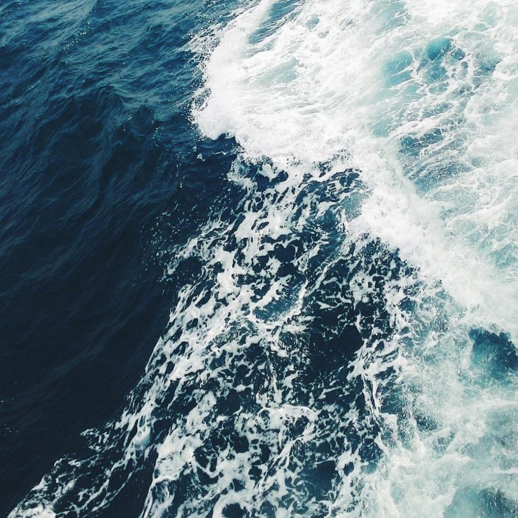 Aerial view of ocean waves crashing into each other
