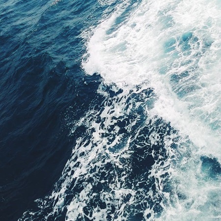 Aerial view of ocean waves crashing into each other