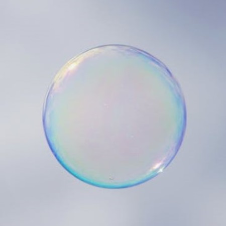 Perfectly round transparent water droplet suspended weightlessly in air